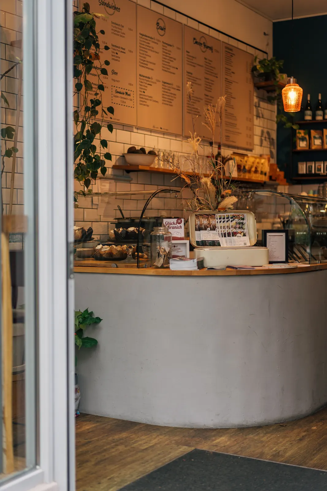Representative welcoming café entrance and counter